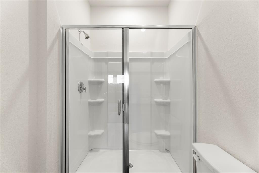 1324 Kennedy Road Howe, TX 75459 - Photo 20 of 29 a bathroom with a glass shower door