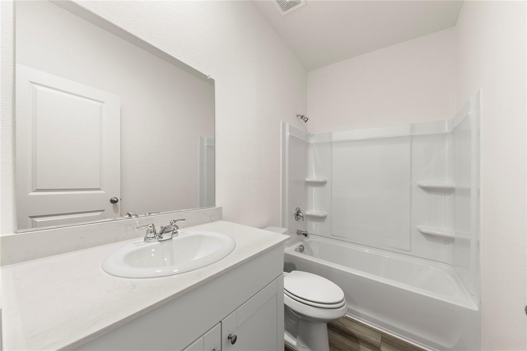 1324 Kennedy Road Howe, TX 75459 - Photo 24 of 29 a bathroom with a sink toilet a mirror and shower