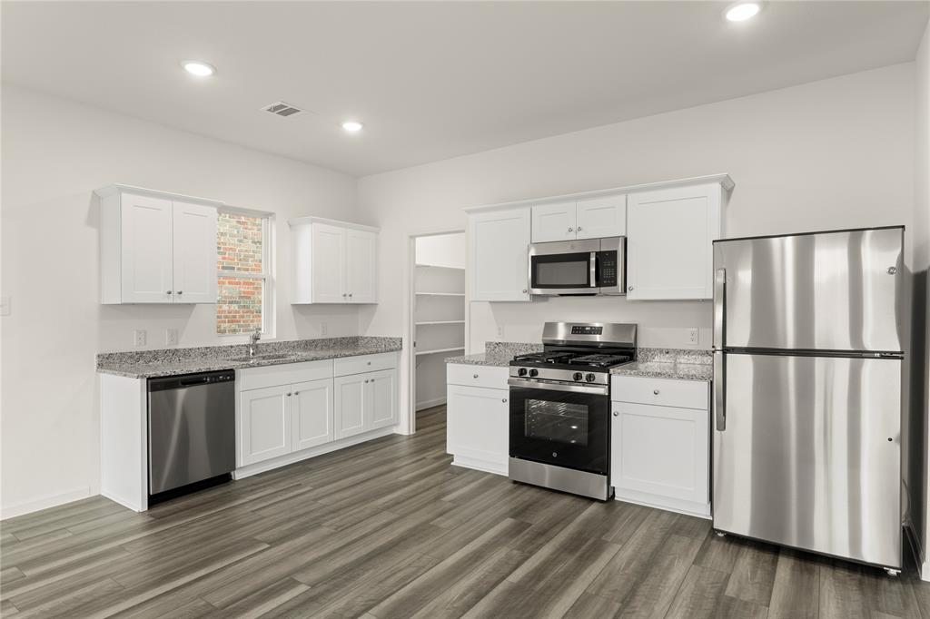 1324 Kennedy Road Howe, TX 75459 - Photo 10 of 29 a kitchen with granite countertop a refrigerator stove top oven and sink