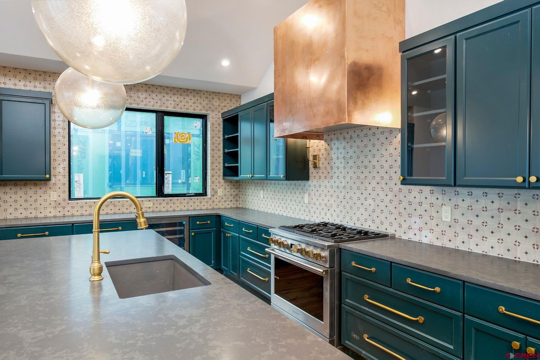 180 Elk Valley Road, Unit 108 Crested Butte, CO 81224 - Photo 7 of 28 a kitchen with stainless steel appliances granite countertop a sink and cabinets