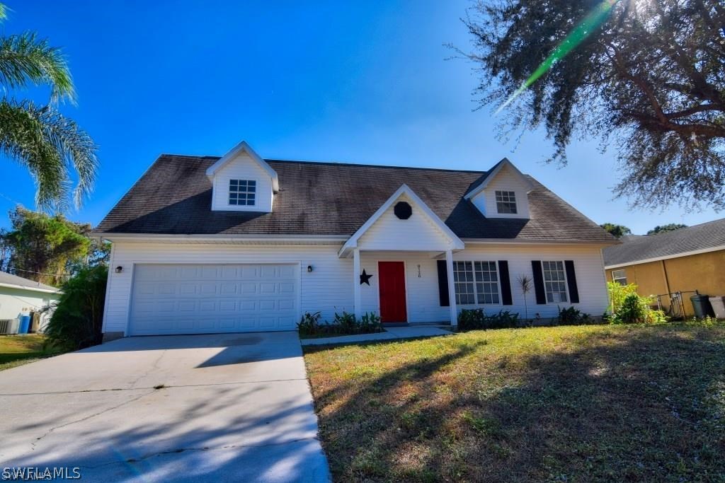 8128 Anhinga Road Fort Myers, FL 33967 - Photo 1 of 12 a front view of a house with a yard