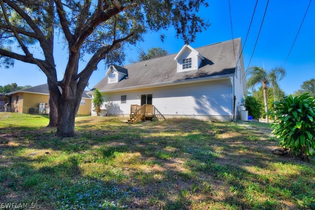 8128 Anhinga Road Fort Myers, FL 33967 - Photo 2 of 12 a view of a house with a yard
