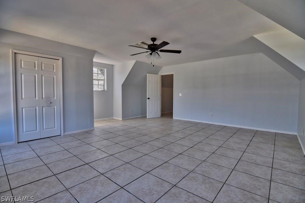 8128 Anhinga Road Fort Myers, FL 33967 - Photo 6 of 12 a view of a livingroom with a chandelier fan and windows