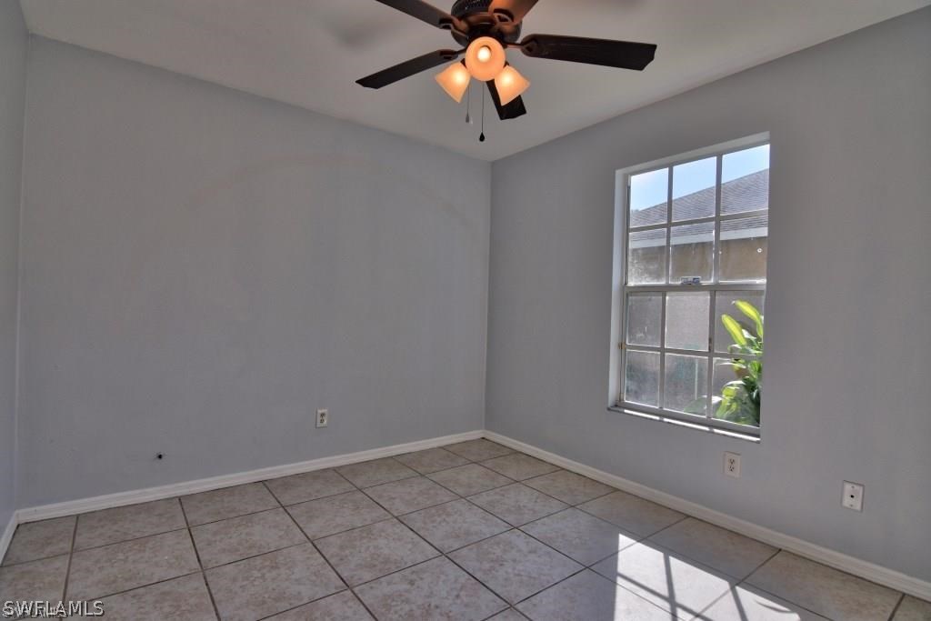 8128 Anhinga Road Fort Myers, FL 33967 - Photo 10 of 12 wooden floor in an empty room with a window