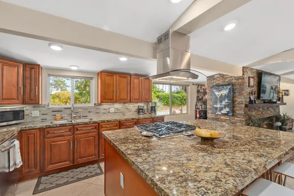 a large kitchen with a table and chairs