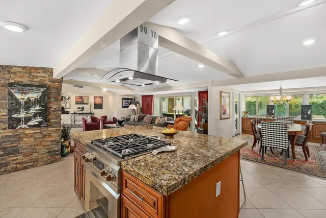 a spacious bedroom with a bed and a chandelier