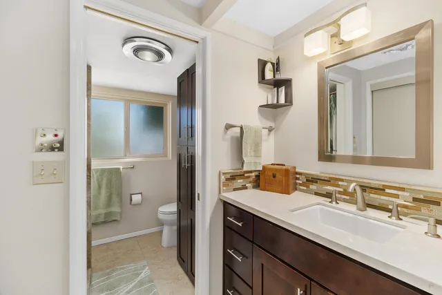 a bathroom with a double vanity sink and a mirror