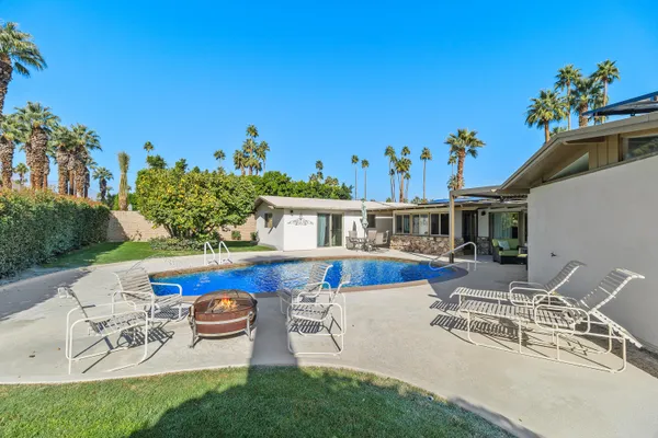 swimming pool view with a lounge chair
