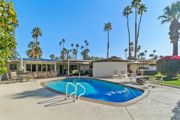 a view of a swimming pool with an outdoor seating