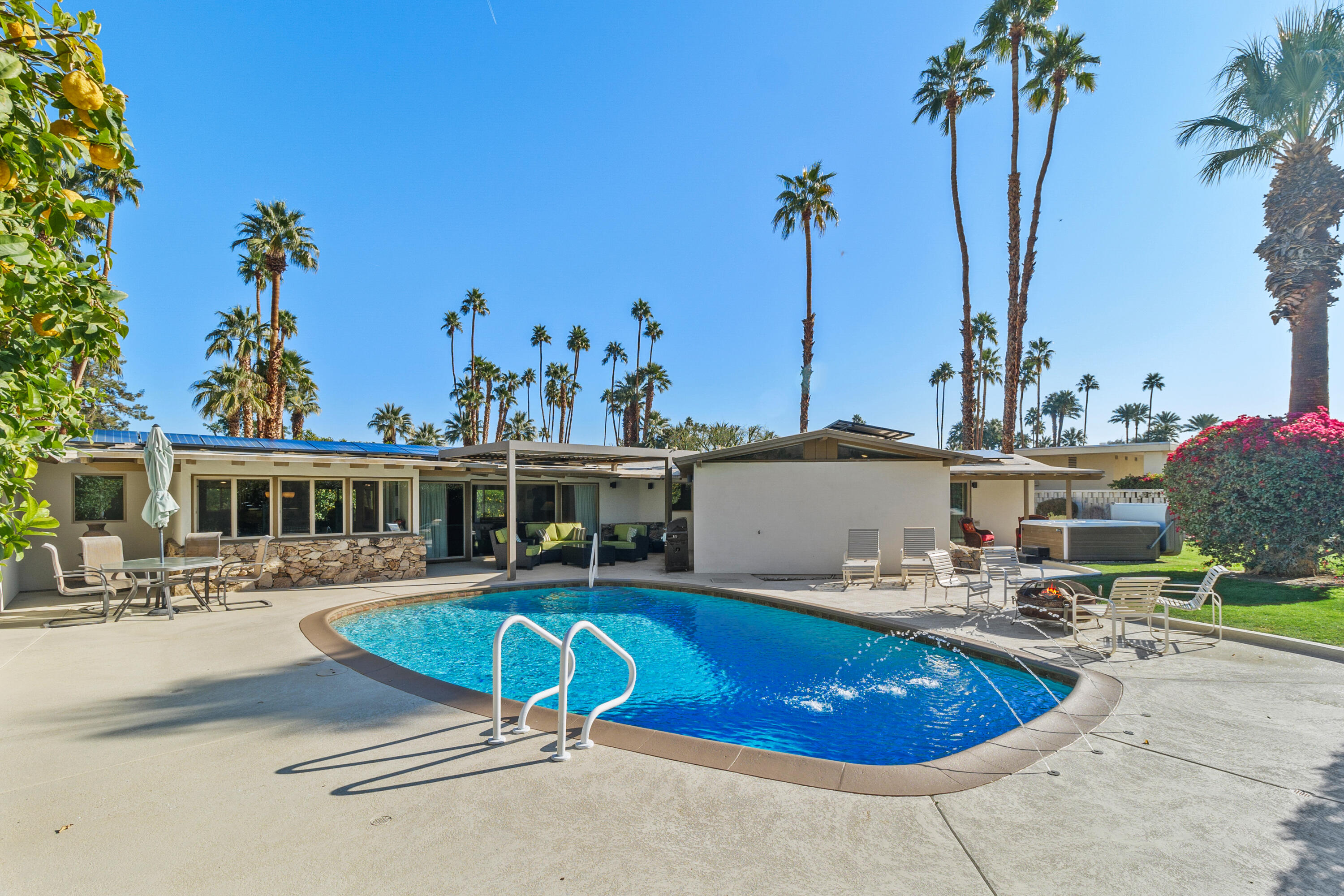 70801 Fairway Drive Rancho Mirage, CA 92270 - Photo 39 of 48 a swimming pool with outdoor seating and yard