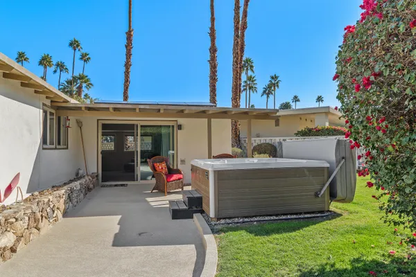 a view of backyard with swimming pool and outdoor seating