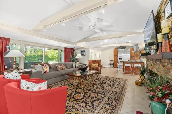 a living room with furniture fireplace and a large window