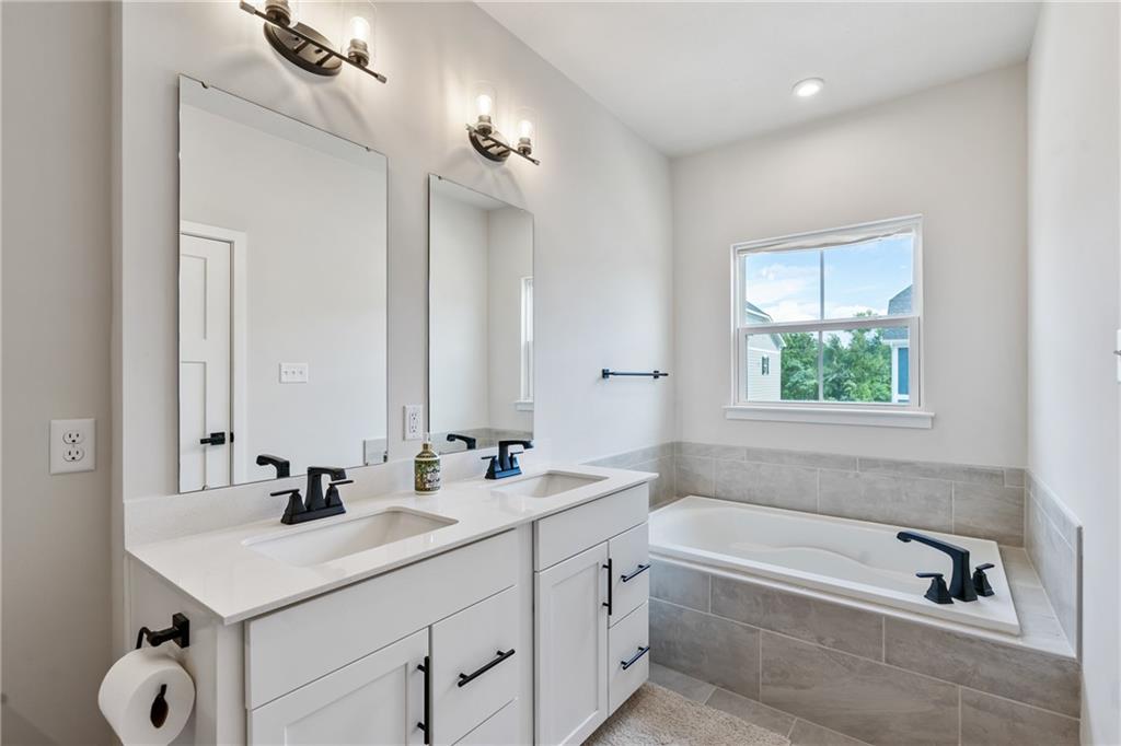 4608 Spruce Road Gibsonia, PA 15044 - Photo 19 of 32 a bathroom with a sink tub double vanity and mirror