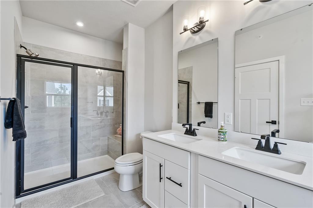 4608 Spruce Road Gibsonia, PA 15044 - Photo 20 of 32 a bathroom with a double vanity sink toilet and shower