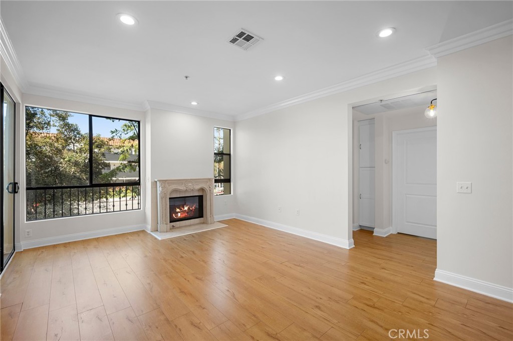 6938 Laurel Canyon Boulevard, Unit 101 North Hollywood, CA 91605 - Photo 11 of 32 wooden floor in an empty room with a fireplace