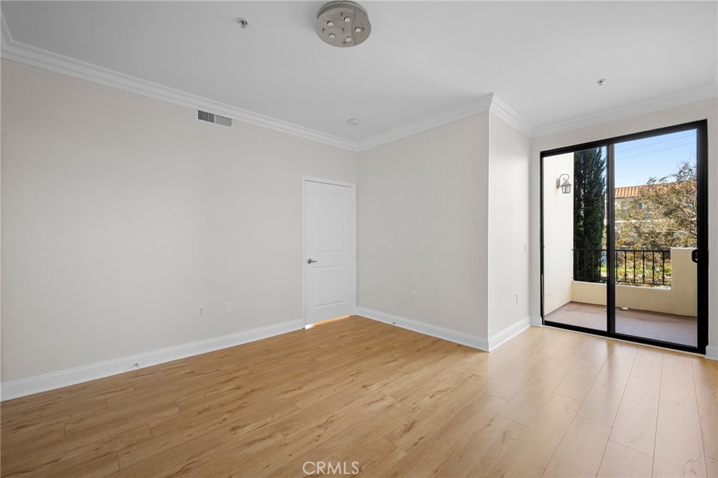 6938 Laurel Canyon Boulevard, Unit 101 North Hollywood, CA 91605 - Photo 16 of 32 wooden floor in an empty room with a window