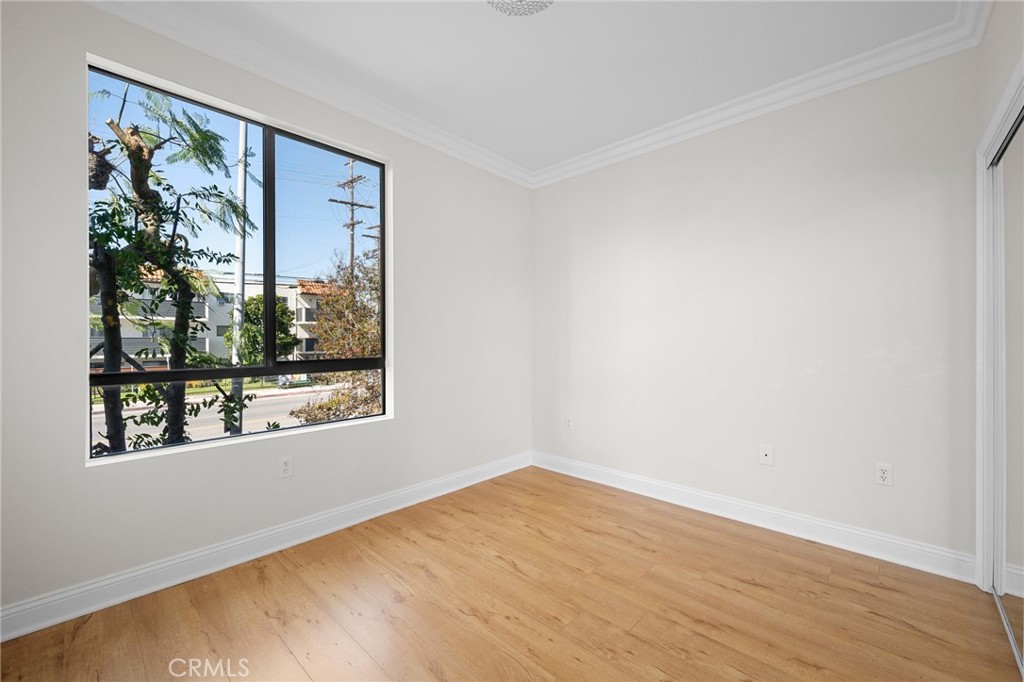 6938 Laurel Canyon Boulevard, Unit 101 North Hollywood, CA 91605 - Photo 21 of 32 a view of empty room with wooden floor and fan