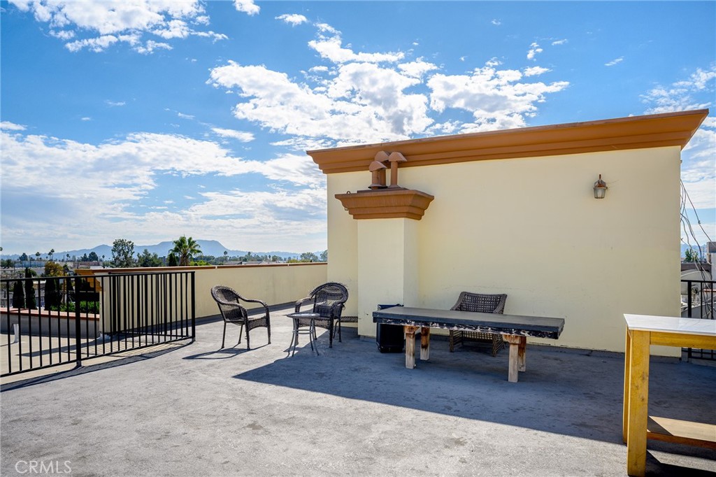 6938 Laurel Canyon Boulevard, Unit 101 North Hollywood, CA 91605 - Photo 28 of 32 a terrace of a house with outdoor seating