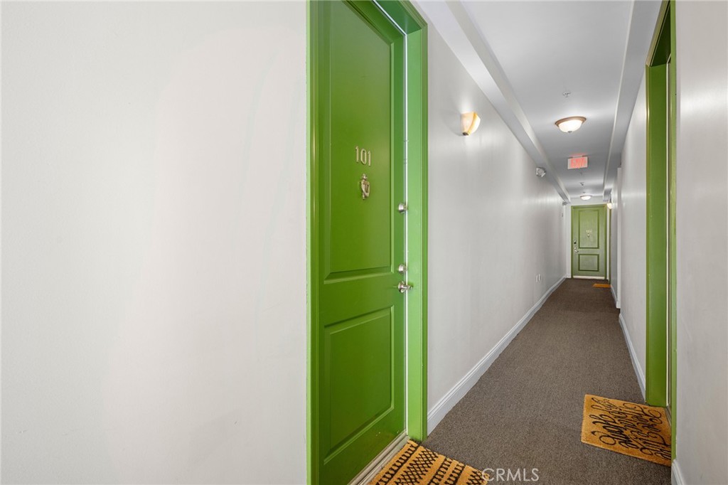 6938 Laurel Canyon Boulevard, Unit 101 North Hollywood, CA 91605 - Photo 3 of 32 a view of a hallway with wooden floor