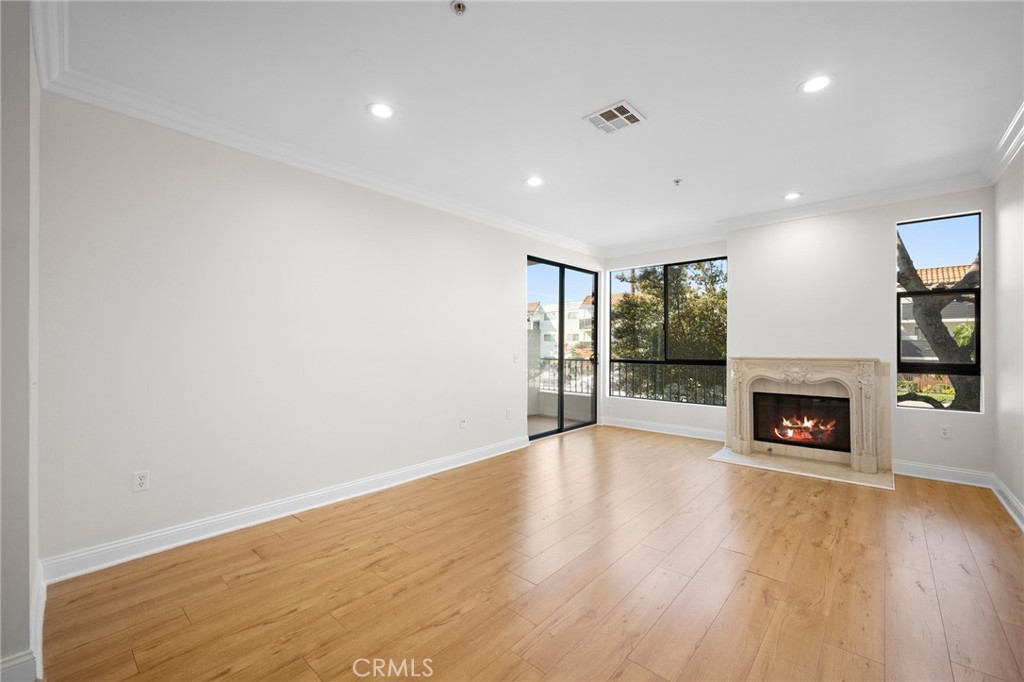 6938 Laurel Canyon Boulevard, Unit 101 North Hollywood, CA 91605 - Photo 6 of 32 a view of an empty room with fire place and a fireplace