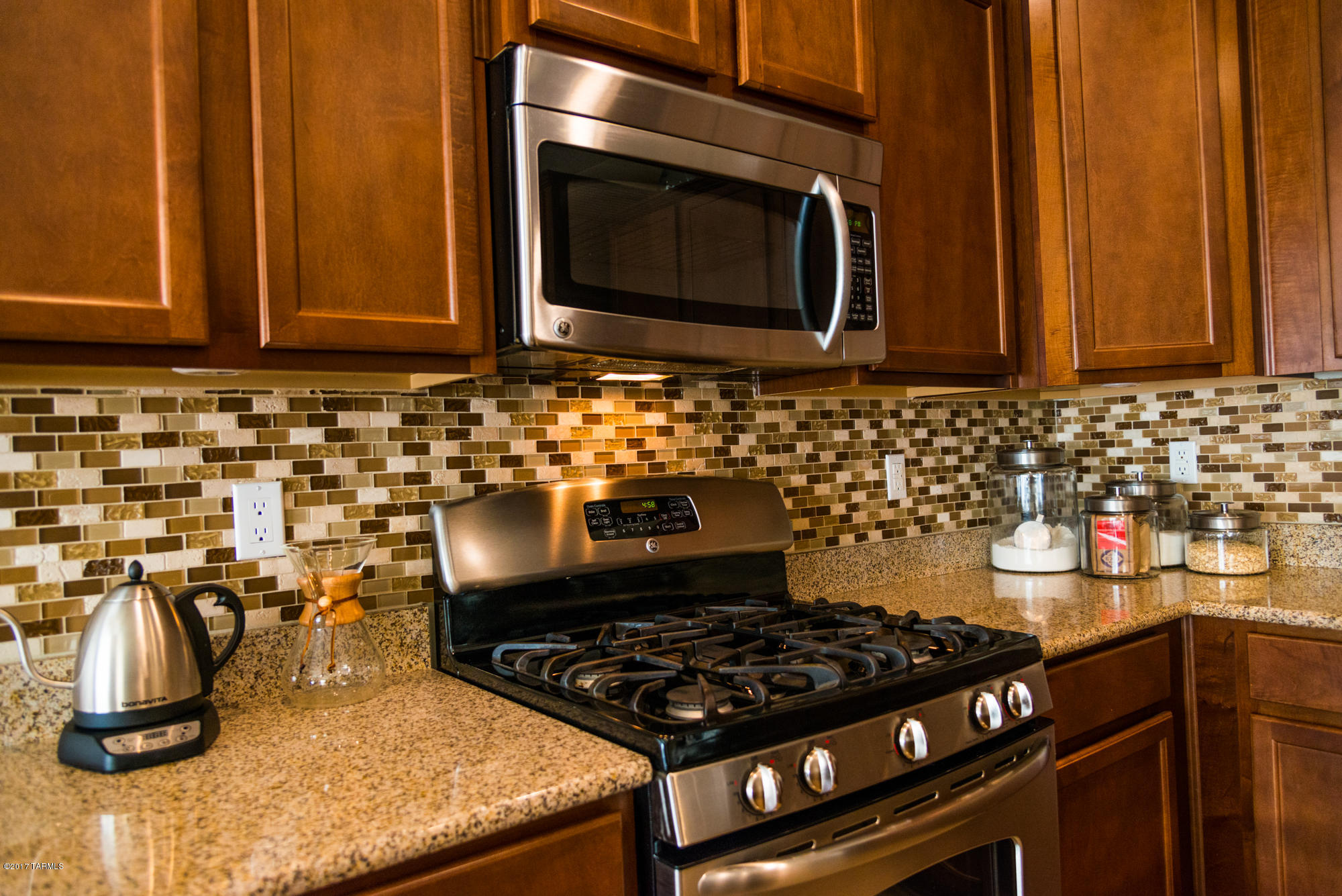 4405 West Crystal Ranch Place Marana, AZ 85658 - Photo 6 of 44 a kitchen with a stove and a microwave