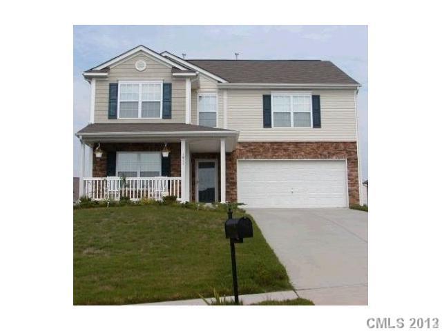 a view of a brick house with a yard