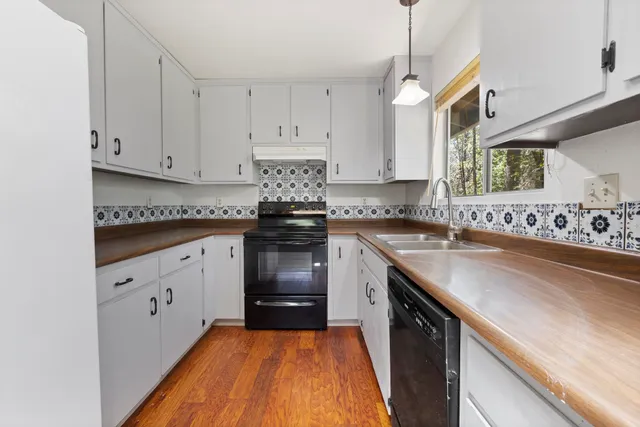 a kitchen with white cabinets and a sink