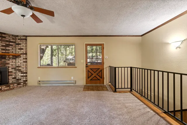 a view of empty room with fireplace and window