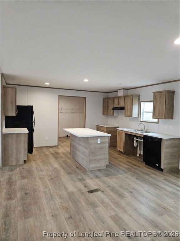 1693 Odum Road Lumberton, NC 28360 - Photo 2 of 21 a large living room with stainless steel appliances kitchen island a sink dishwasher a stove and a refrigerator with wooden floor