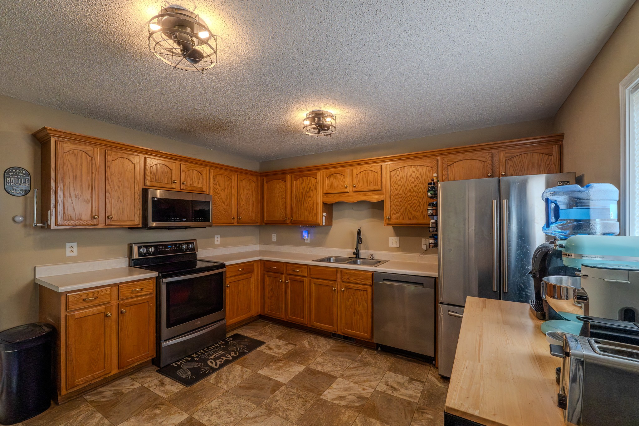 1735 Hazelwood Road Clarksville, TN 37042 - Photo 14 of 23 a kitchen with stainless steel appliances granite countertop a sink a stove a refrigerator cabinets and a dining table