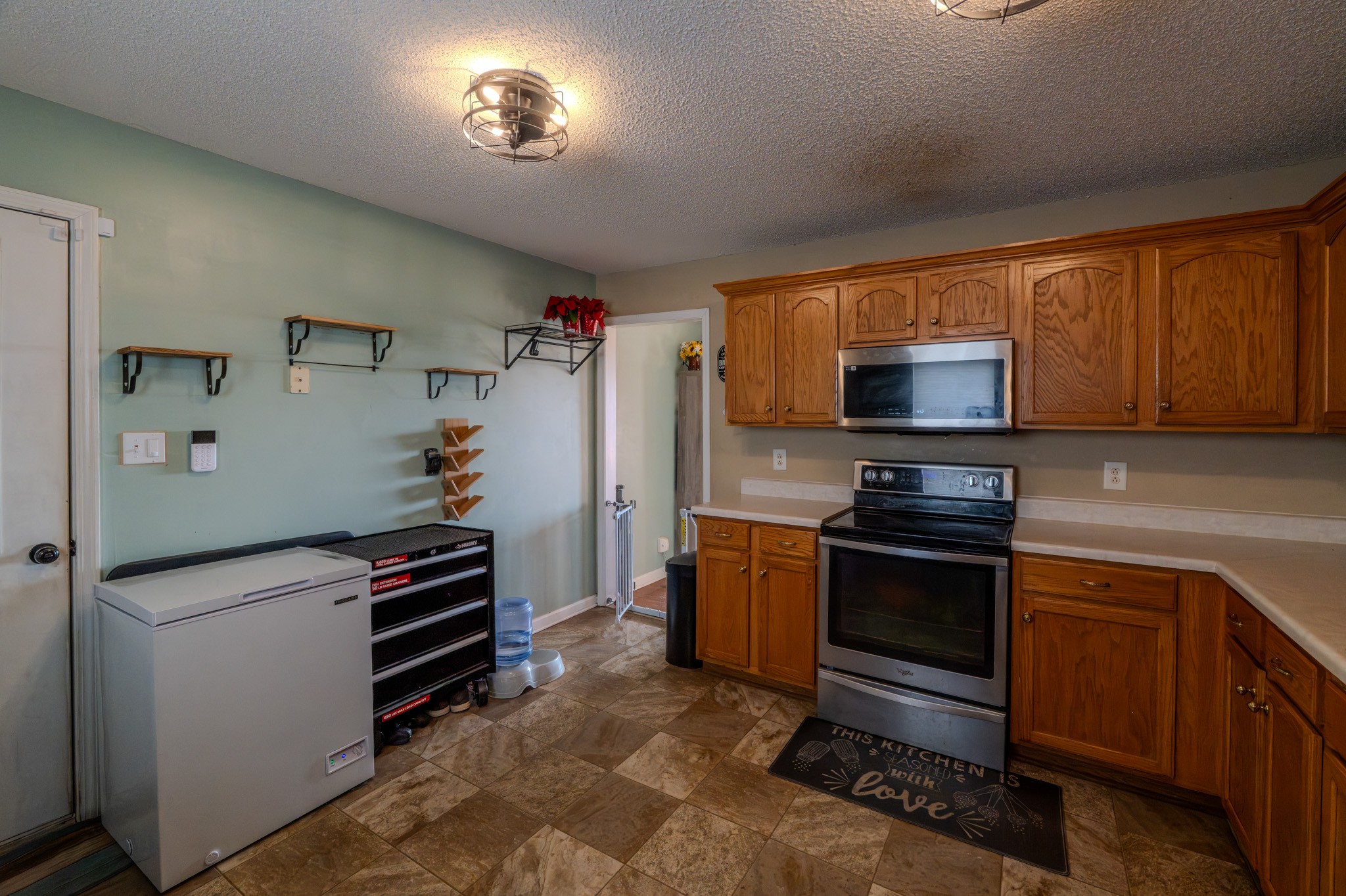1735 Hazelwood Road Clarksville, TN 37042 - Photo 15 of 23 a kitchen with stainless steel appliances a stove refrigerator sink and microwave