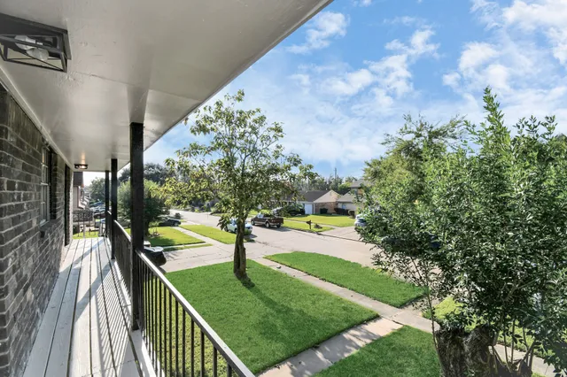 a view of a hallway with wooden floor and a table