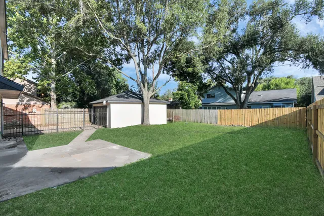 a view of a backyard with large trees