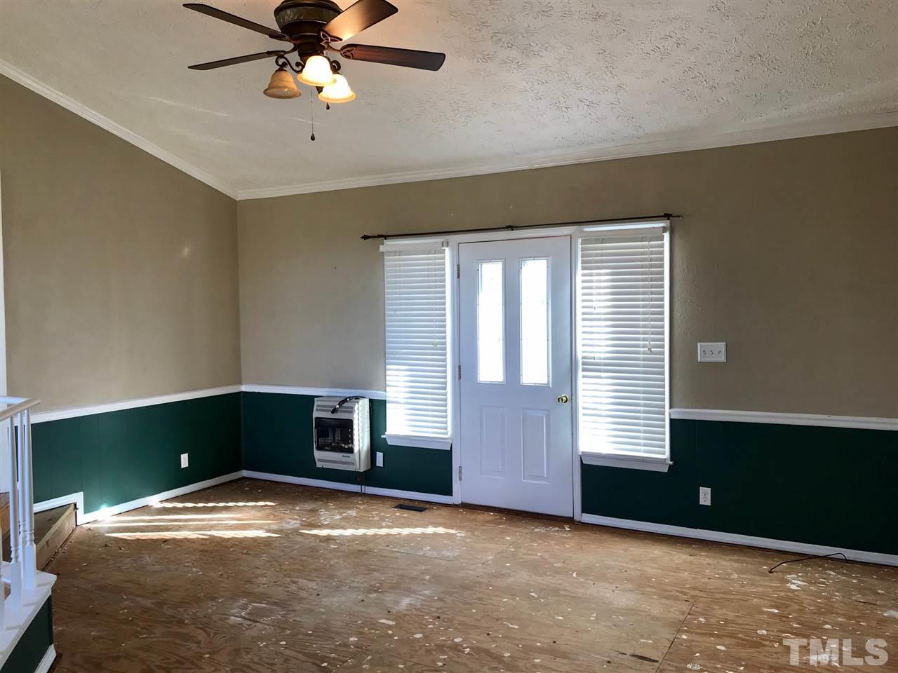 9419 Virgilina Road Roxboro, NC 27574 - Photo 14 of 30 a view of empty room with window and fireplace