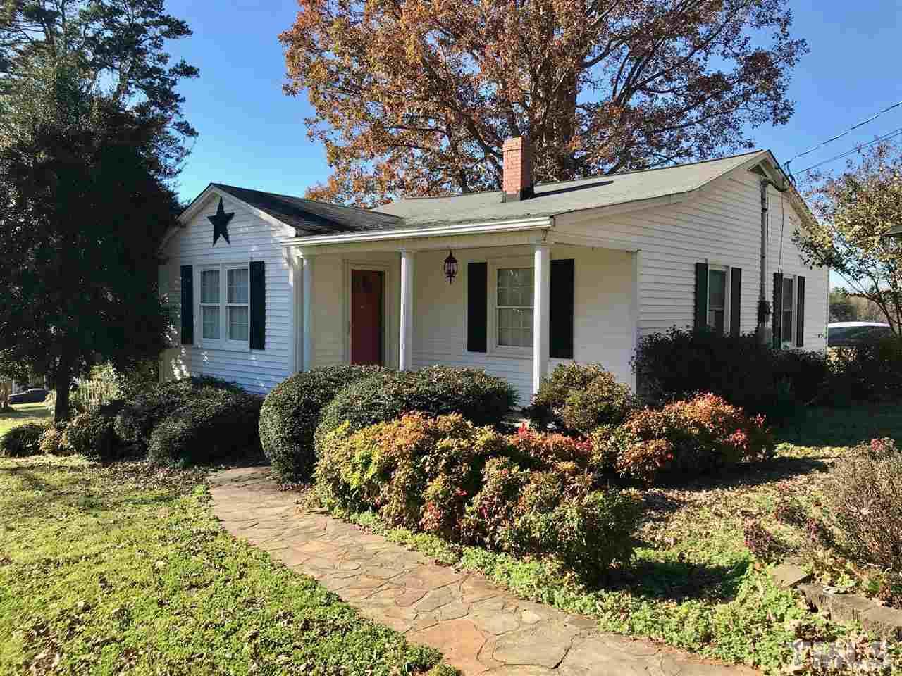 9419 Virgilina Road Roxboro, NC 27574 - Photo 3 of 30 a front view of a house with a yard and outdoor seating