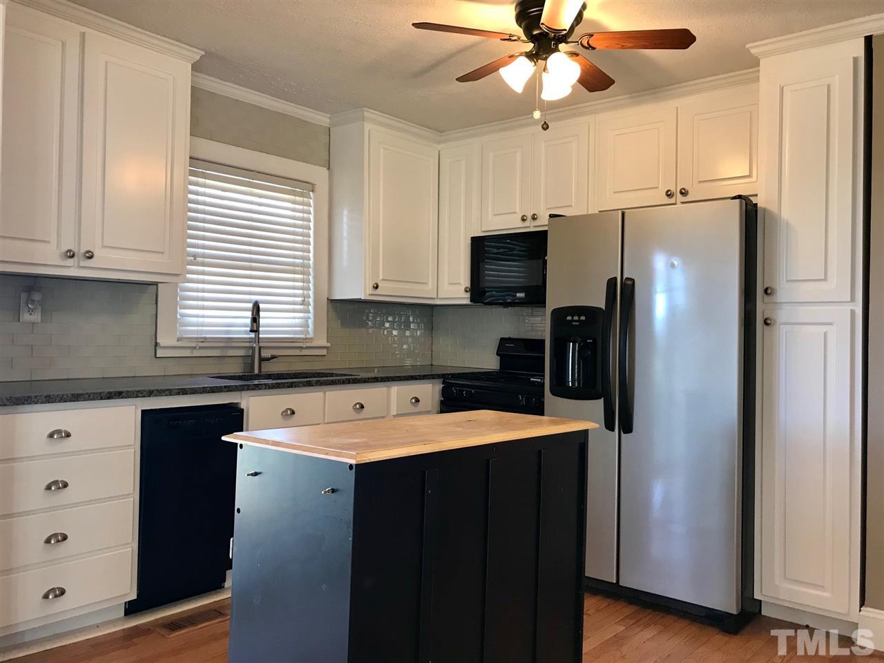 9419 Virgilina Road Roxboro, NC 27574 - Photo 8 of 30 a kitchen with stainless steel appliances a refrigerator sink and cabinets