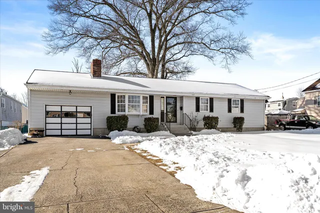a view of a house with a yard covered in snow