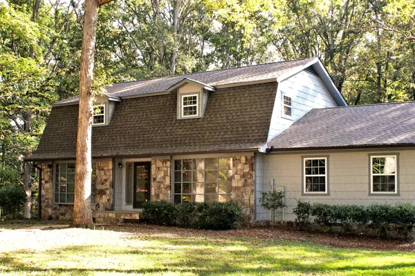a front view of house with yard and swimming pool