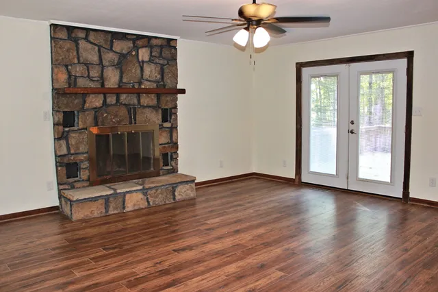 a view of a livingroom with wooden floor and a ceiling fan