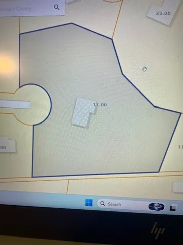 a view of a room with window and wooden floor