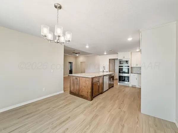 a view of a kitchen with a sink and wooden floor