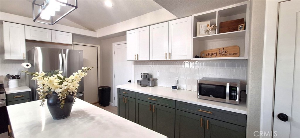 14822 Crofton Lane Helendale, CA 92342 - Photo 15 of 33 a kitchen with a stove a sink and cabinets