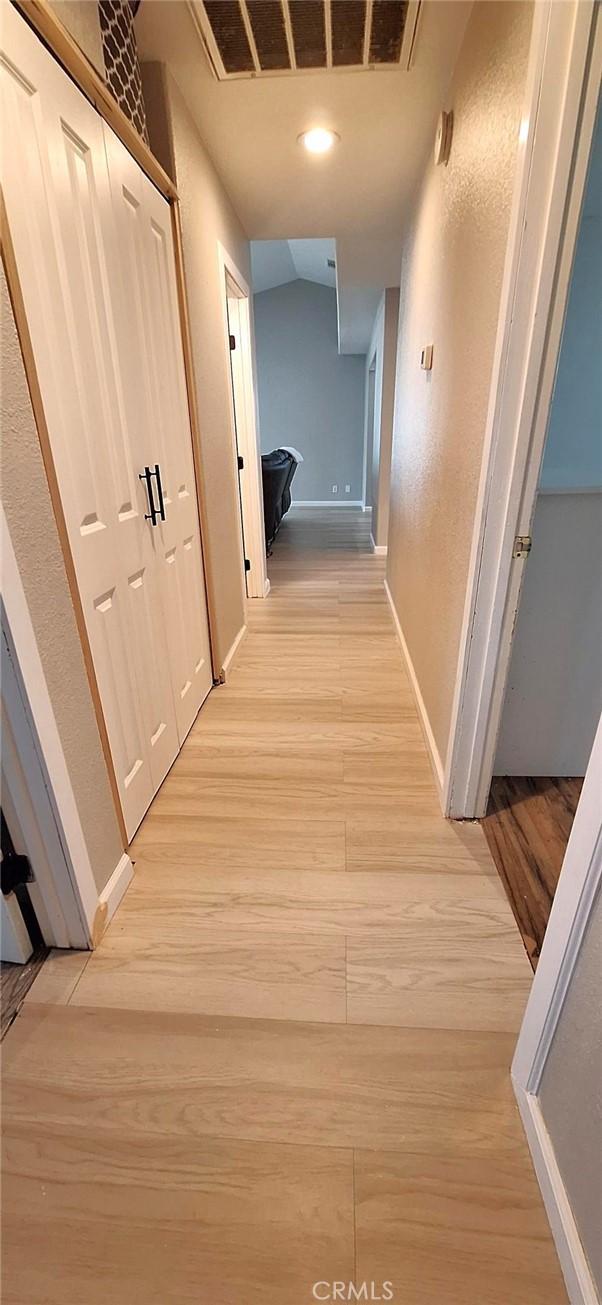 14822 Crofton Lane Helendale, CA 92342 - Photo 22 of 33 a view of a hallway with wooden floor and staircase