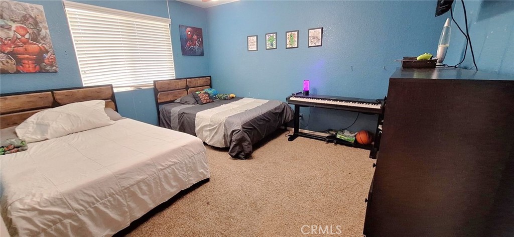 14822 Crofton Lane Helendale, CA 92342 - Photo 25 of 33 a bedroom with bed and window