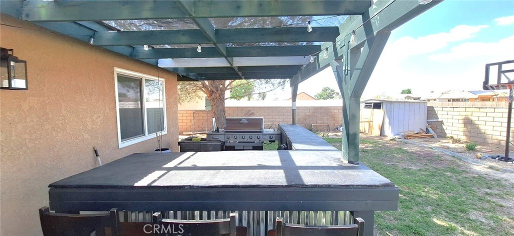 14822 Crofton Lane Helendale, CA 92342 - Photo 31 of 33 a view of a patio with a table chairs and wooden floor