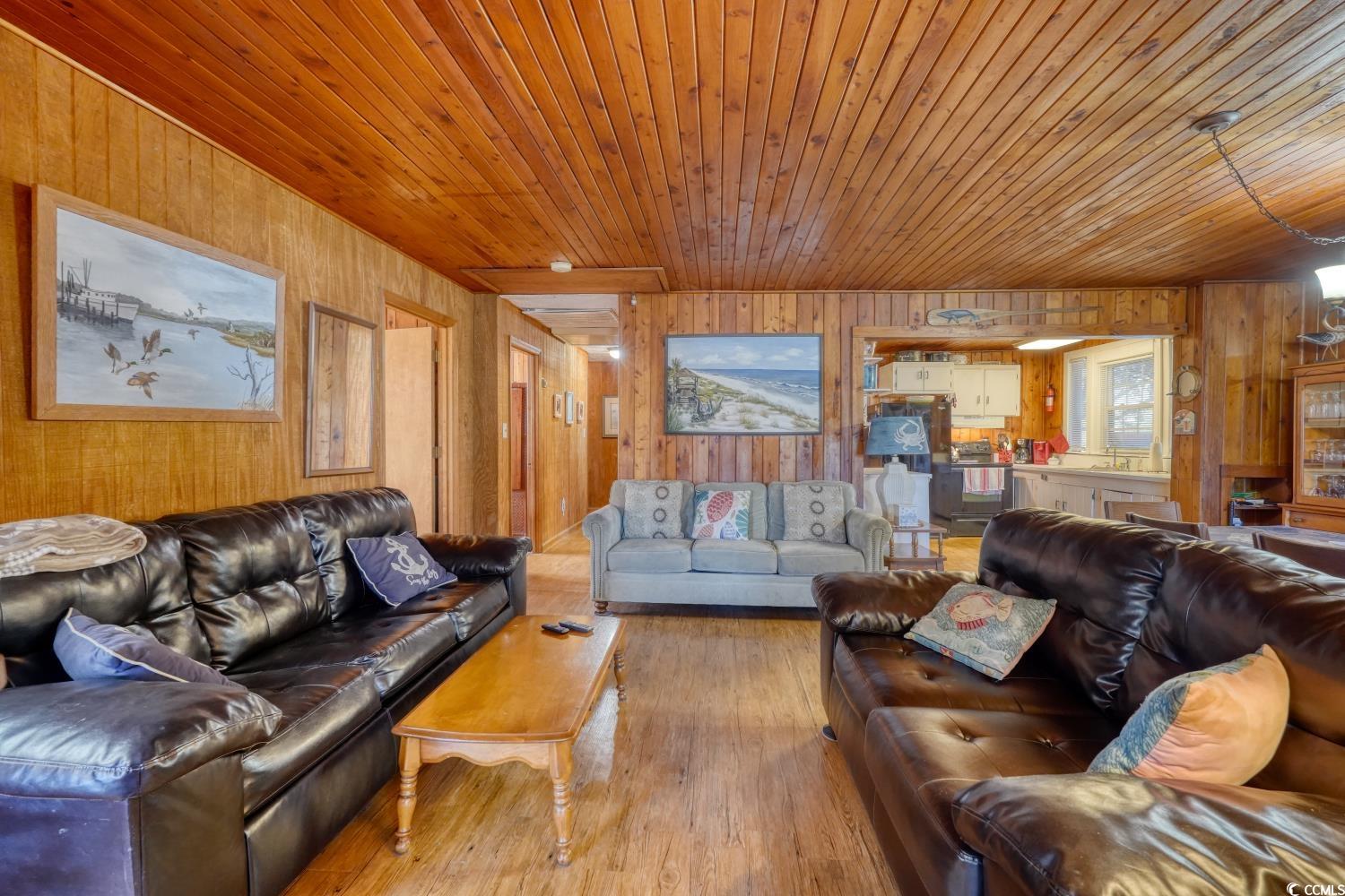 350 Underwood Drive Murrells Inlet, SC 29576 - Photo 17 of 36 Living area with wood walls, hardwood / wood-style floors, and wooden ceiling