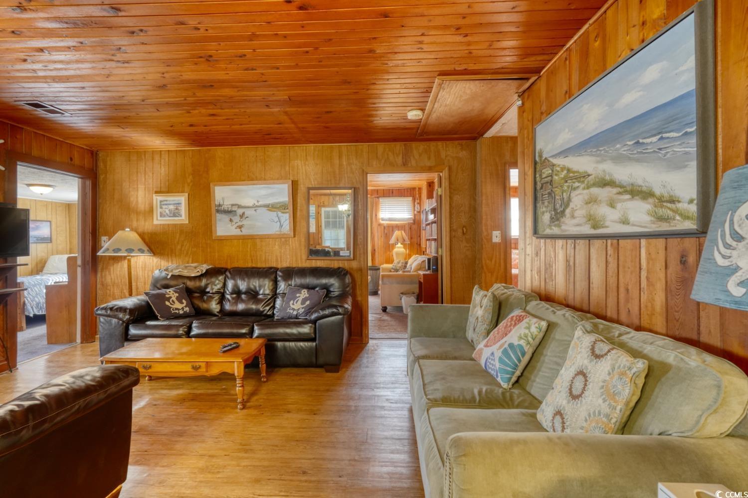 350 Underwood Drive Murrells Inlet, SC 29576 - Photo 19 of 36 Living room with wooden walls, wooden ceiling, and light wood-style flooring