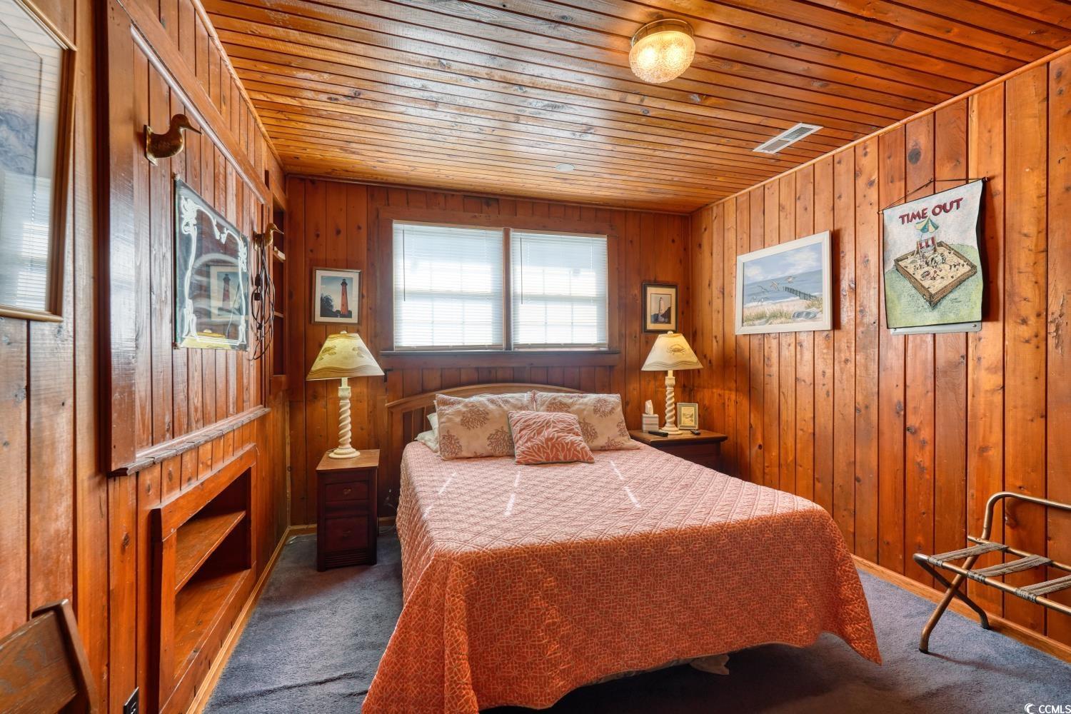 350 Underwood Drive Murrells Inlet, SC 29576 - Photo 25 of 36 Carpeted bedroom featuring wooden ceiling and wooden walls