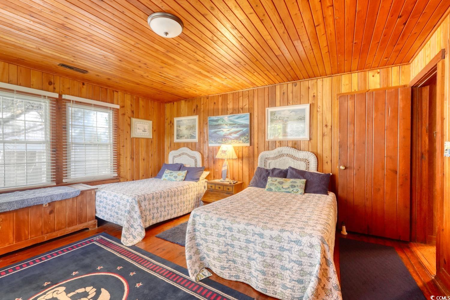 350 Underwood Drive Murrells Inlet, SC 29576 - Photo 32 of 36 Bedroom featuring hardwood / wood-style floors, wooden ceiling, and wooden walls
