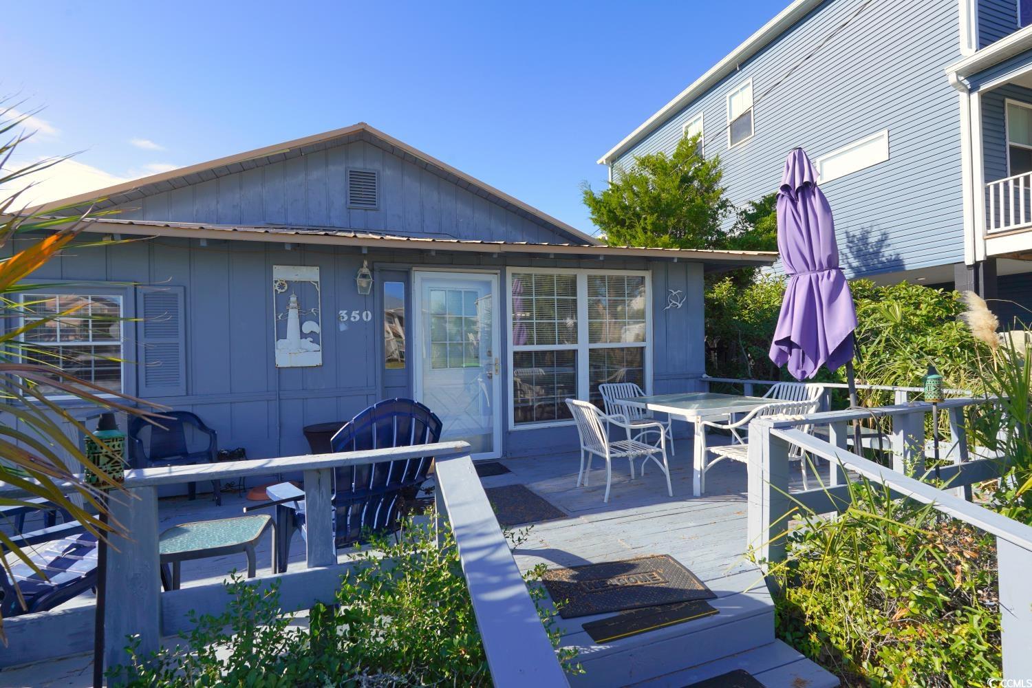 350 Underwood Drive Murrells Inlet, SC 29576 - Photo 4 of 36 Wooden terrace featuring outdoor dining space